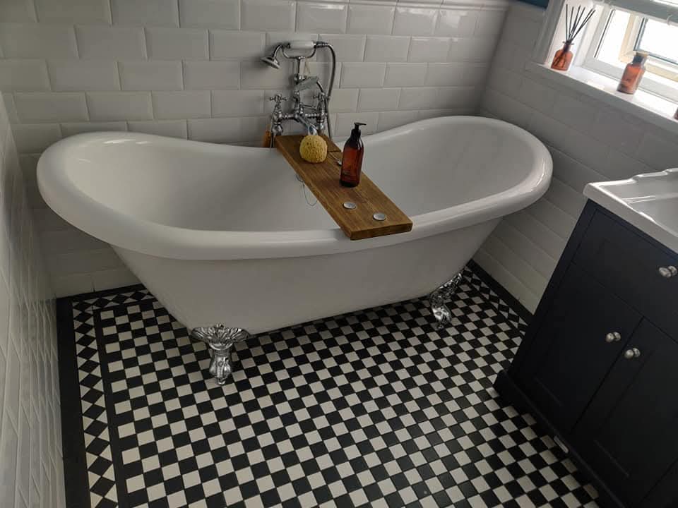 Fully tiled wet room with frameless glass partition and linear drain