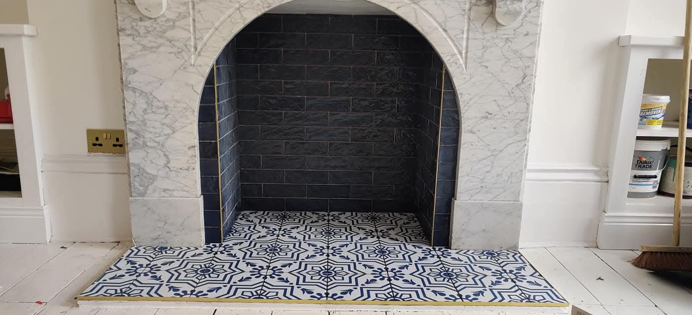 Bespoke fireplace tiling with decorative patterned hearth tiles